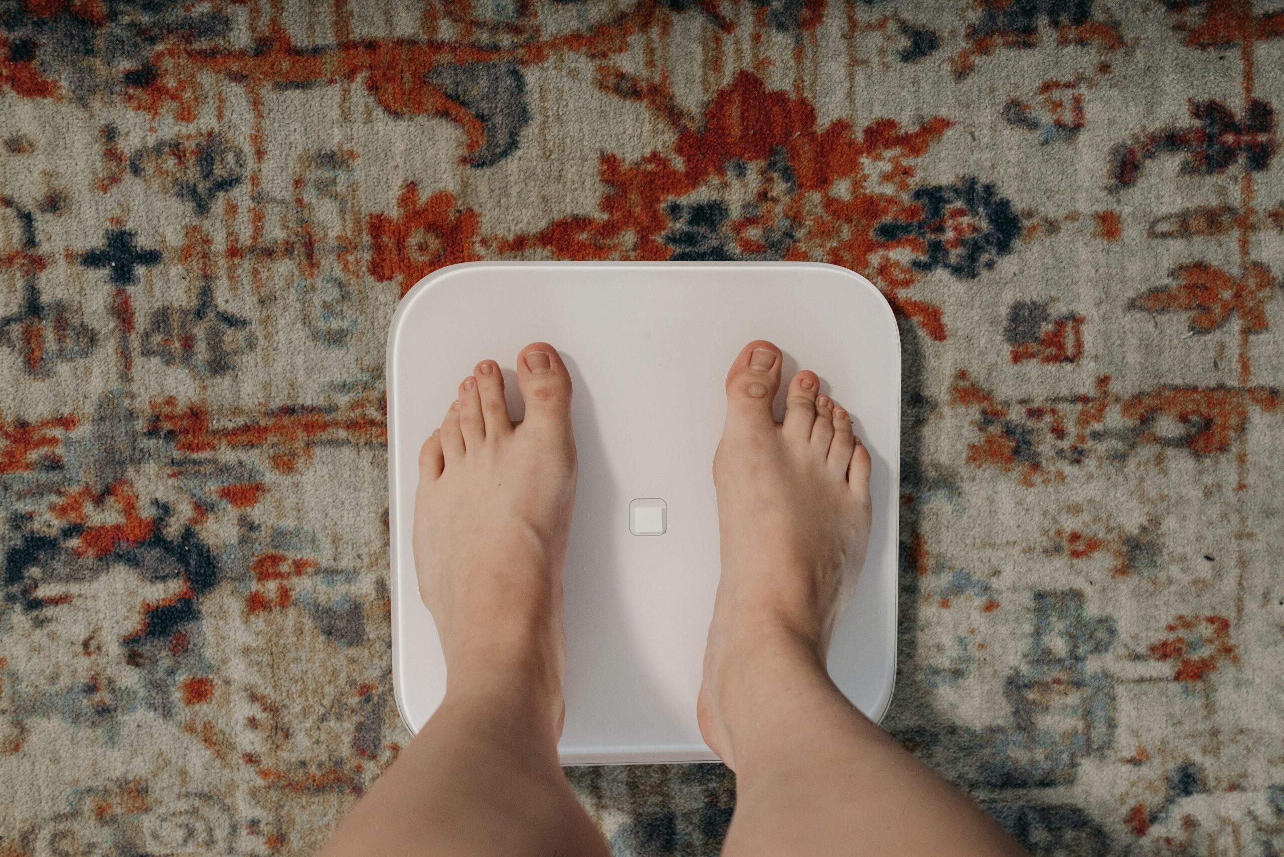 Woman with eating disorder checking her weight